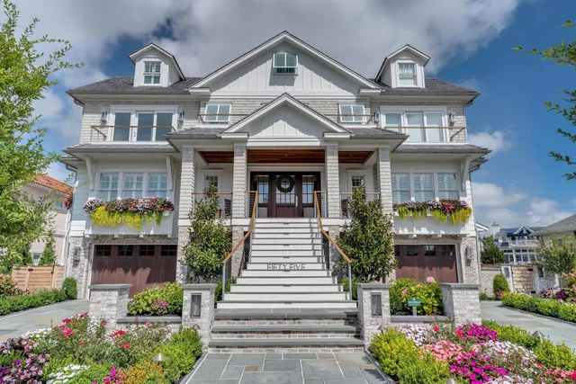 a front view of a house with plants and garden