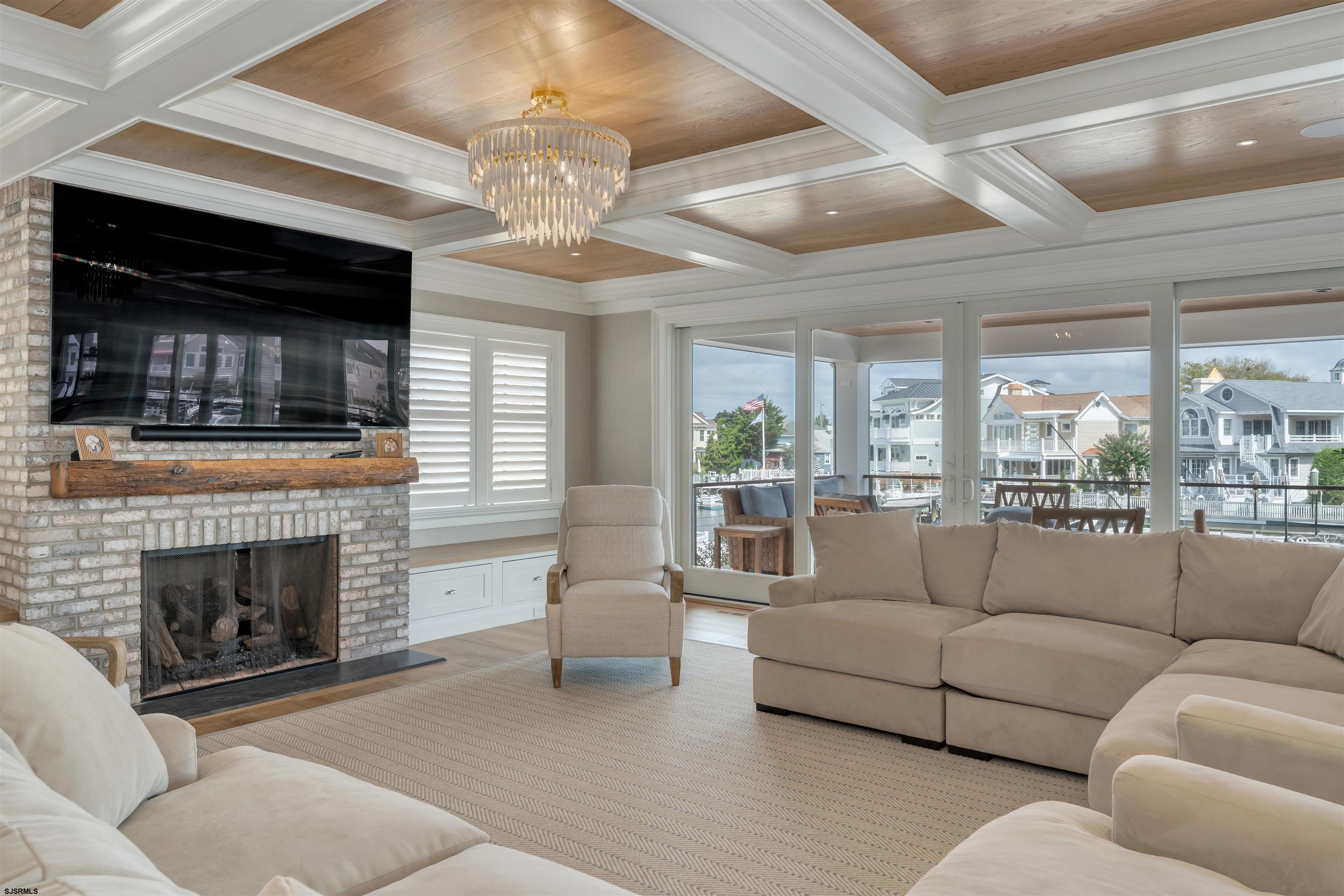 55 Walnut Road Ocean City, NJ 08226 - Photo 13 of 72 a living room with furniture a fireplace and a chandelier