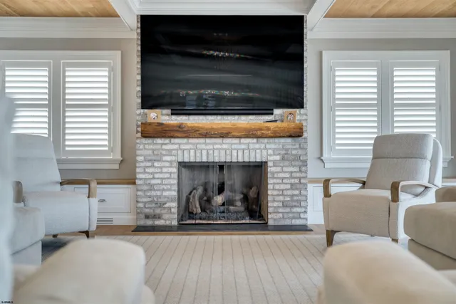 a dining room with furniture a chandelier and kitchen view