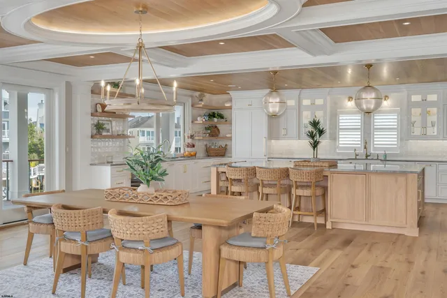 a kitchen with stainless steel appliances granite countertop a sink a stove and a wooden floors