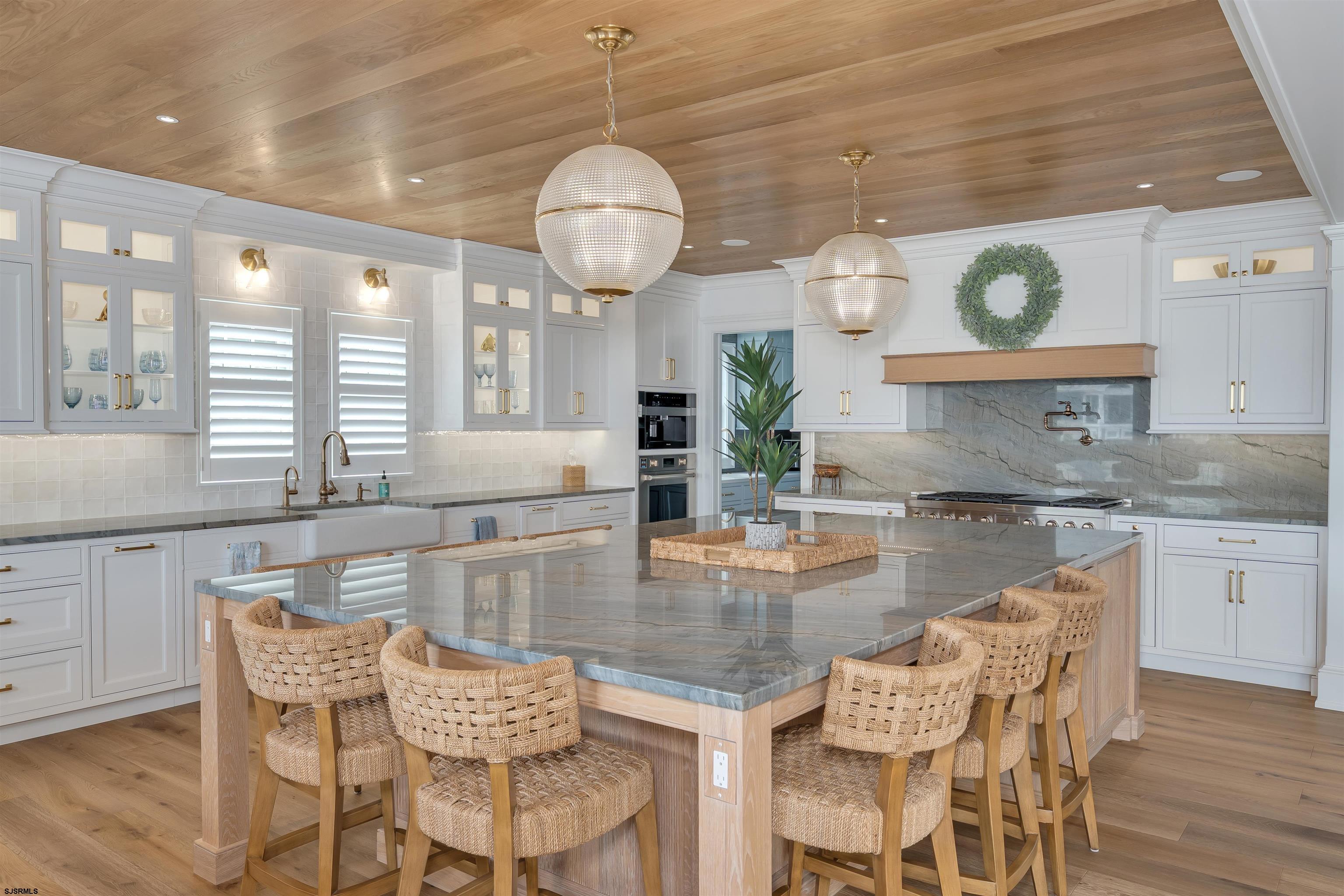 55 Walnut Road Ocean City, NJ 08226 - Photo 27 of 72 a dining room with wooden floor a chandelier a wooden table and chairs
