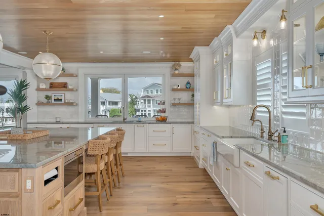 a white kitchen with a sink and cabinets
