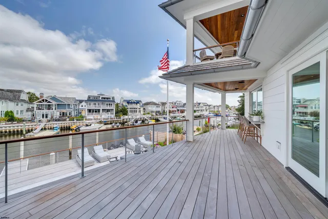 a view of a balcony with wooden floor and outdoor seating
