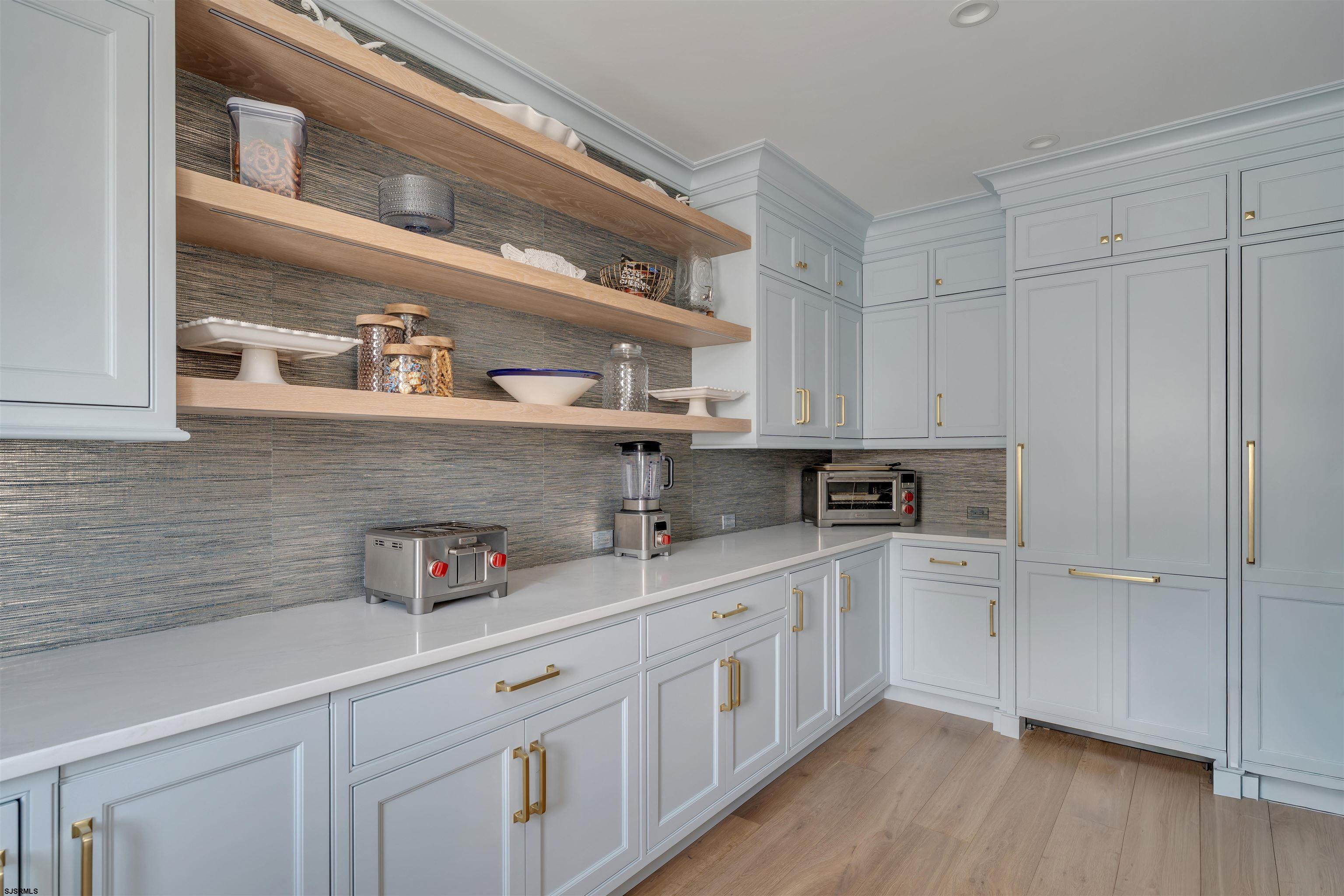 55 Walnut Road Ocean City, NJ 08226 - Photo 47 of 72 a kitchen with stainless steel appliances white cabinets and wooden floor