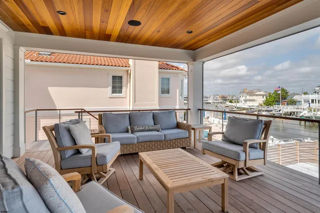 a living room with stainless steel appliances granite countertop furniture wooden floor and window