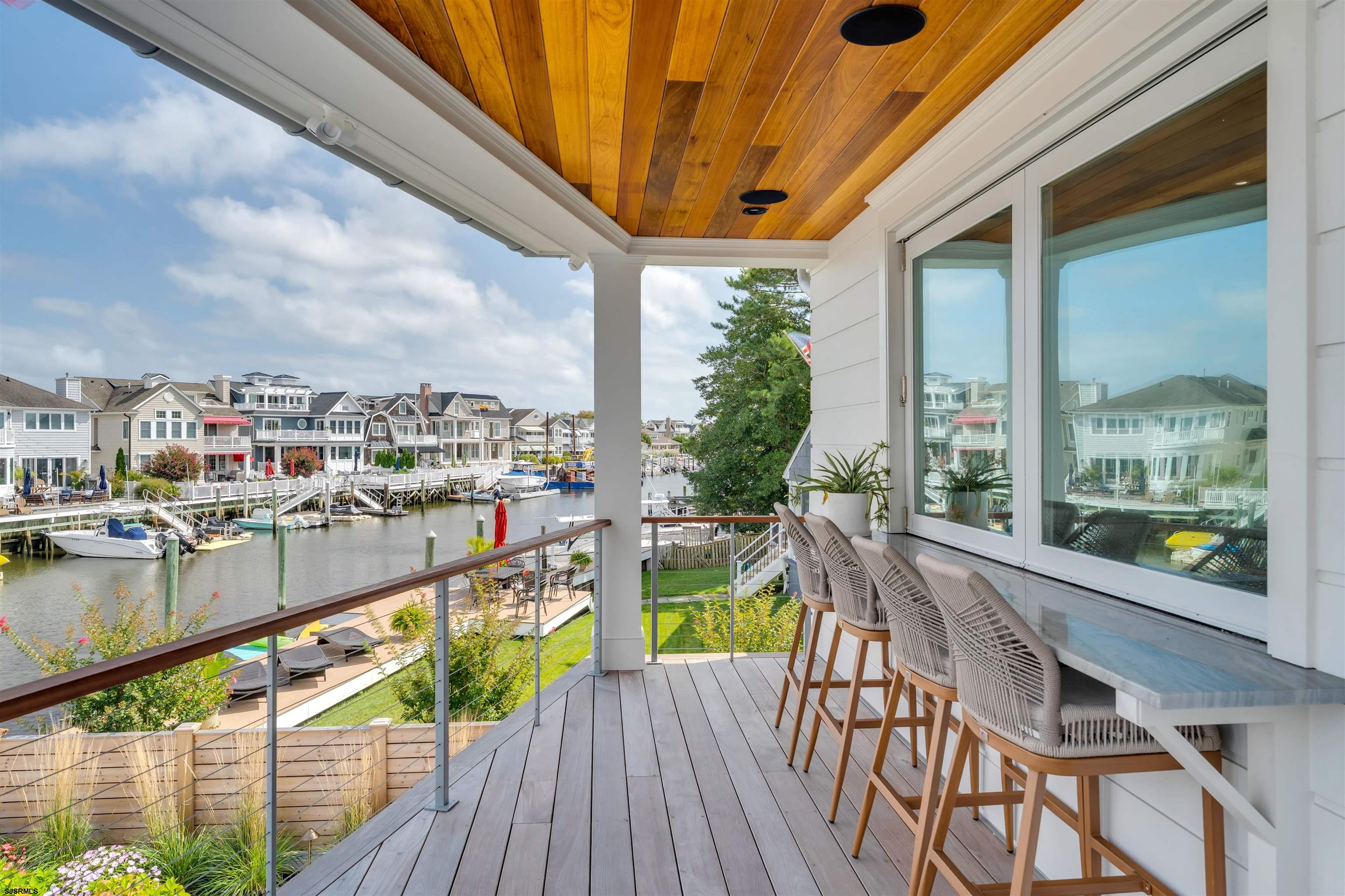 55 Walnut Road Ocean City, NJ 08226 - Photo 6 of 72 a view of a balcony with wooden floor and outdoor seating