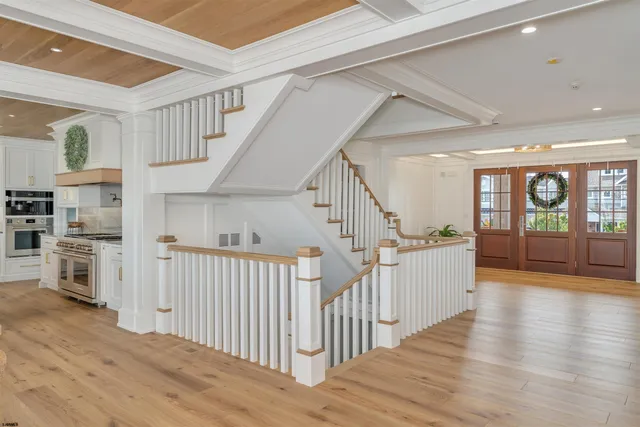 a living room with furniture a fireplace and a large window
