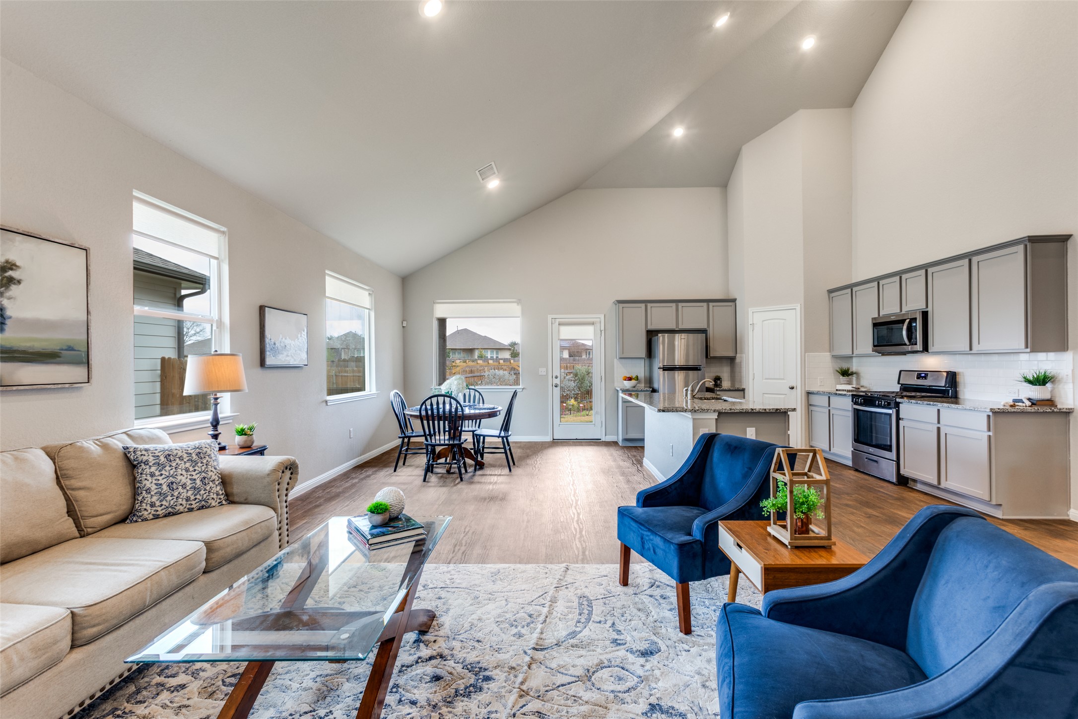 111 Rainmaker Cove Bastrop, TX 78602 - Photo 1 of 1 Living area featuring high vaulted ceiling, vinyl floors, and recessed lighting