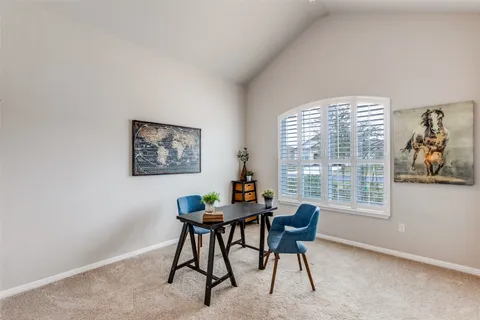 a workspace room with furniture and a window