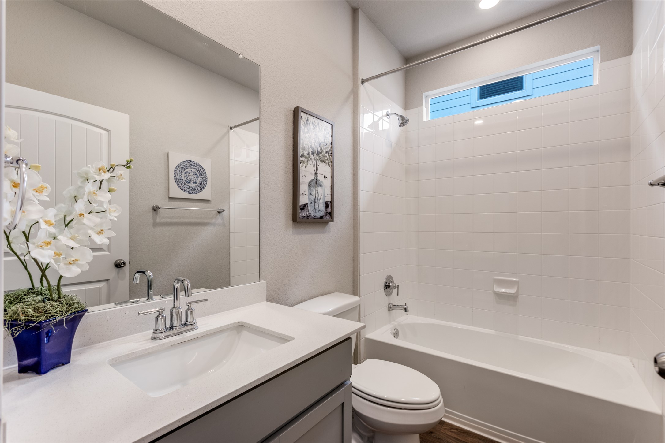 111 Rainmaker Cove Bastrop, TX 78602 - Photo 17 of 36 a bathroom with a granite countertop sink toilet a mirror and shower