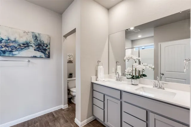 a bathroom with a shower and a bedroom