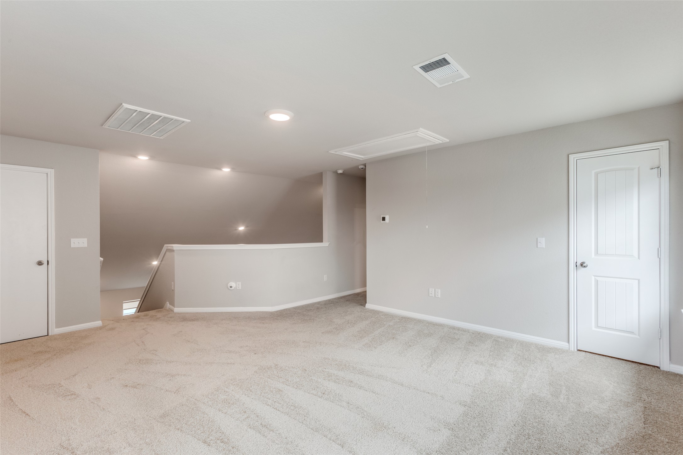 111 Rainmaker Cove Bastrop, TX 78602 - Photo 24 of 36 a view of kitchen and hall with a wooden cabinets