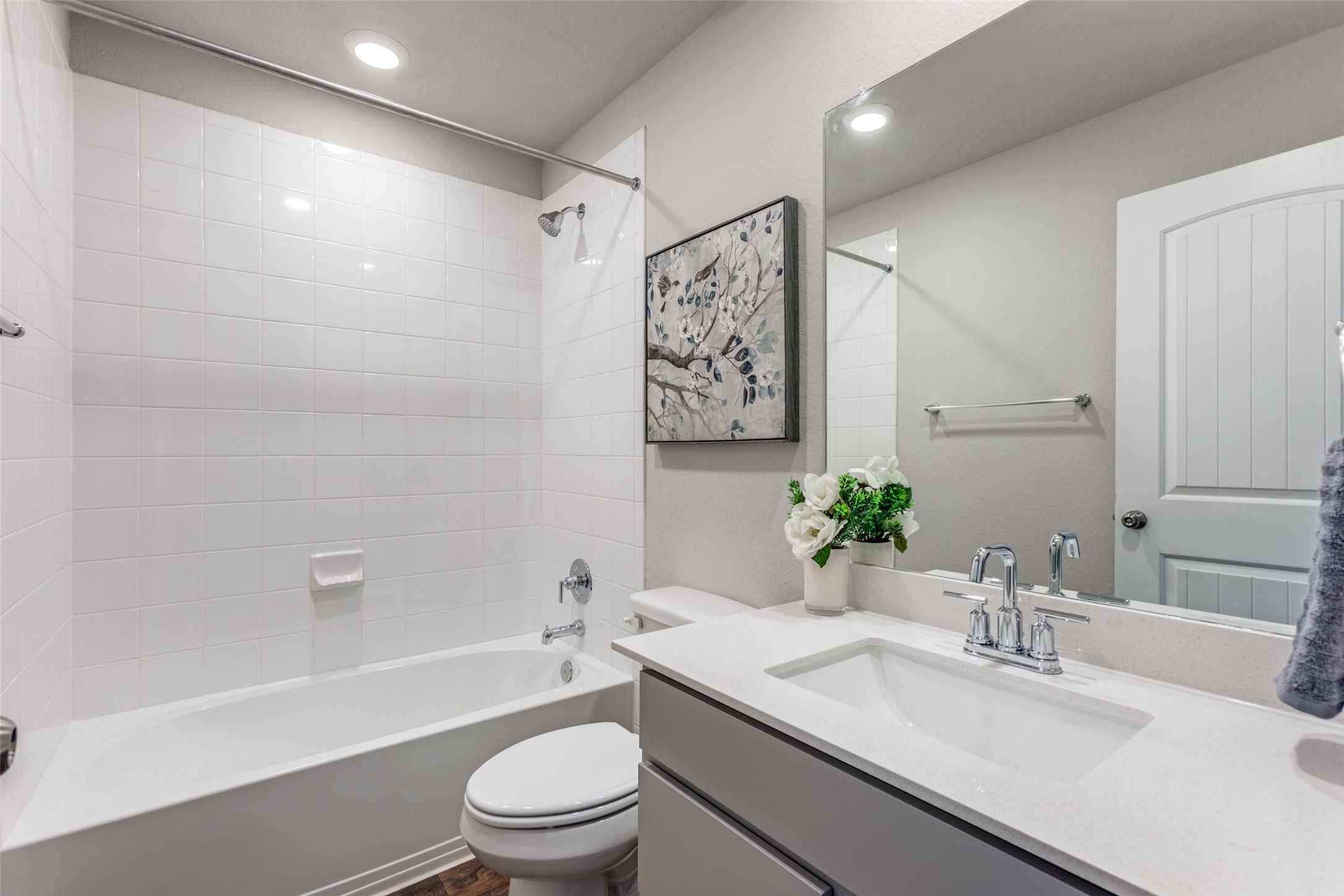 111 Rainmaker Cove Bastrop, TX 78602 - Photo 27 of 36 a bathroom with a granite countertop sink a toilet a mirror a vanity and shower