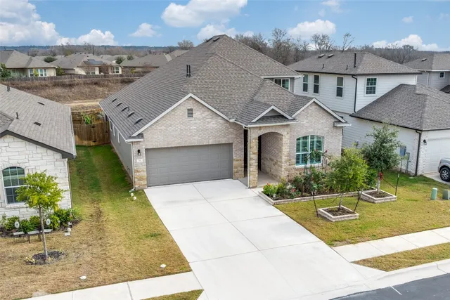 an aerial view of a house with a yard