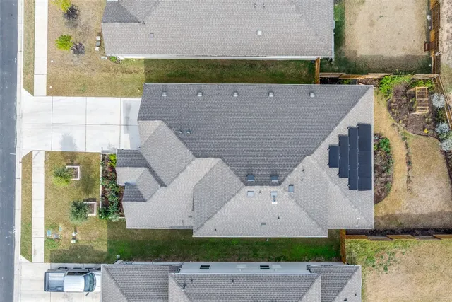 an aerial view of residential houses with outdoor space