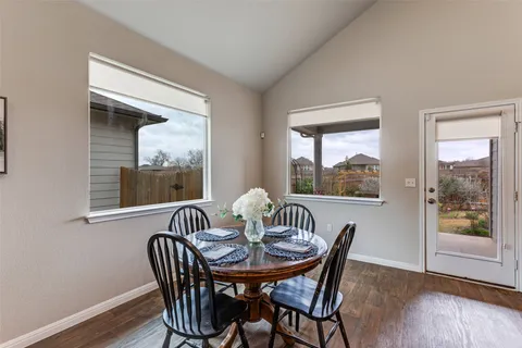 a view of a dining room with furniture wooden floor and a window