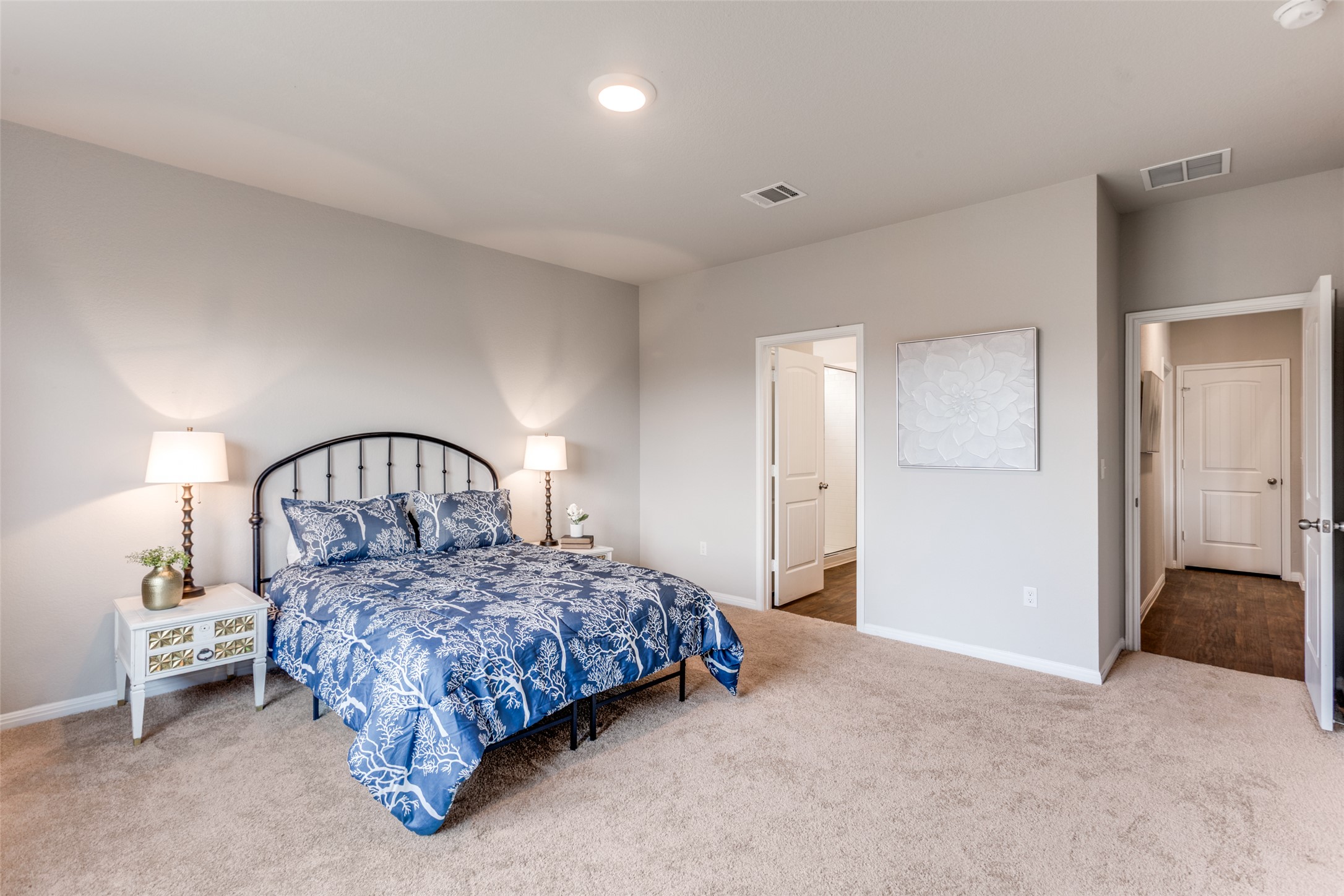 111 Rainmaker Cove Bastrop, TX 78602 - Photo 7 of 36 a bedroom with a bed a lamp and dresser