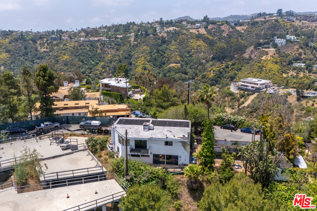 an aerial view of multiple houses with yard