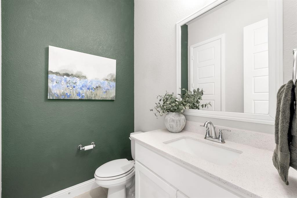 2270 English Ivy Road Frisco, TX 75033 - Photo 20 of 39 a bathroom with a granite countertop sink a toilet and a large mirror