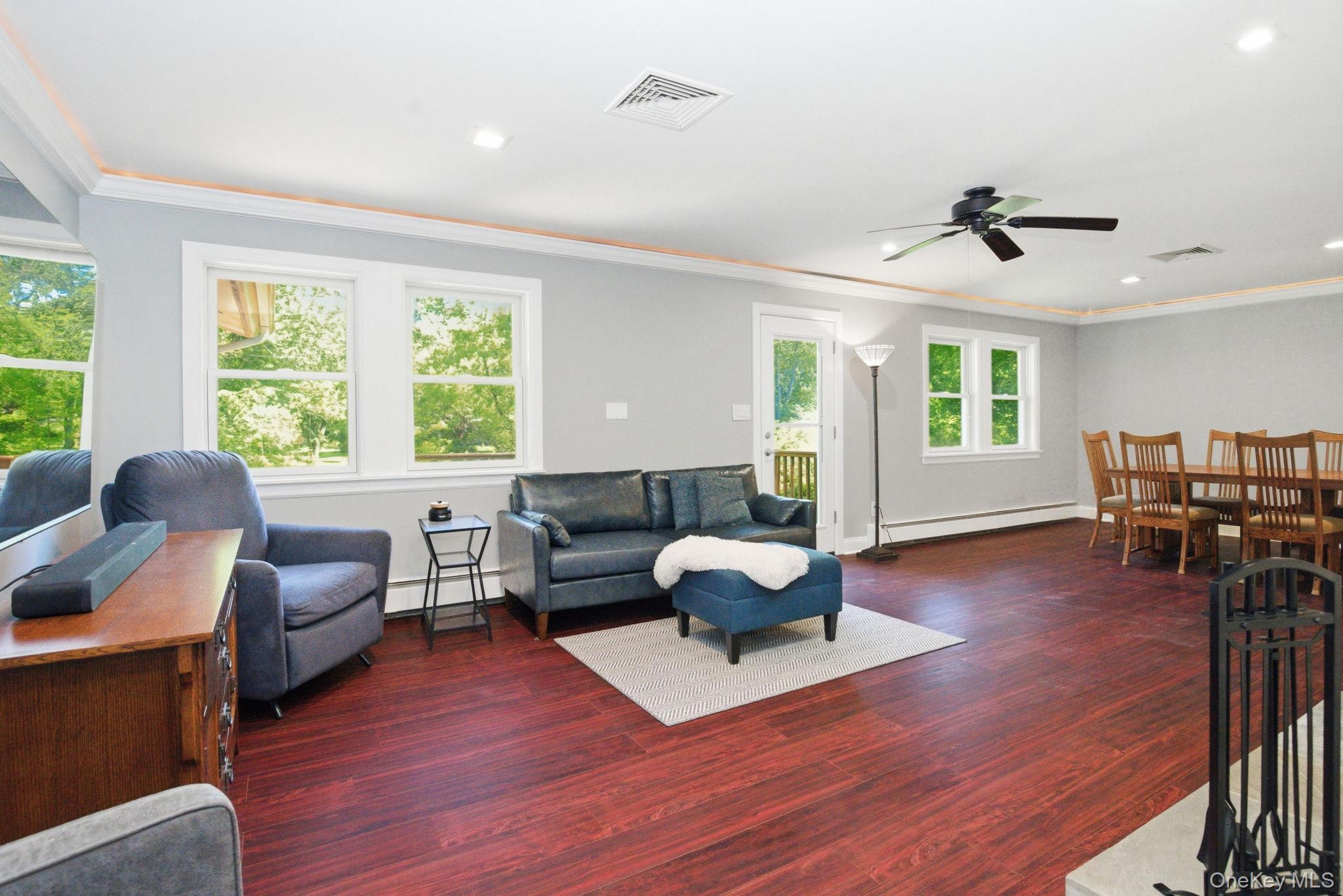 35 Deans Bridge Road Somers, NY 10589 - Photo 14 of 49 Sun-filled living and dining spaces flow together beneath custom lighted crown molding.
