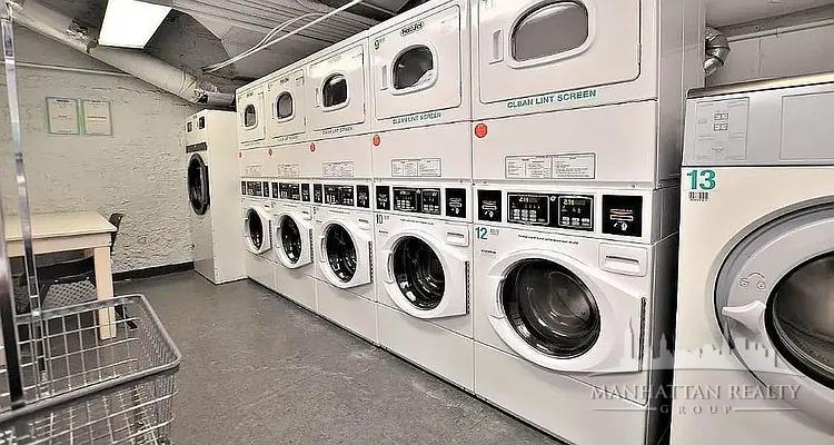 108 East 38th Street, Unit 407 Manhattan, NY 10016 - Photo 6 of 8 a utility room with dryer and washer