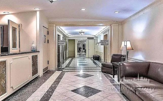 108 East 38th Street, Unit 407 Manhattan, NY 10016 - Photo 7 of 8 a lobby with furniture and a rug