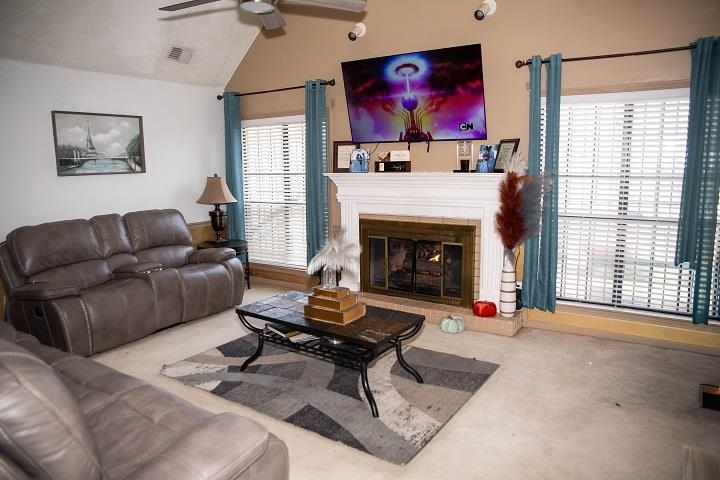 6736 Olivia Forest Road Memphis, TN 38141 - Photo 5 of 18 a living room with furniture a flat screen tv and a fireplace