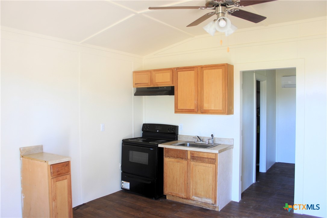 301 Cedar Street, Unit A Lometa, TX 76853 - Photo 11 of 13 a kitchen with a refrigerator and a stove top oven