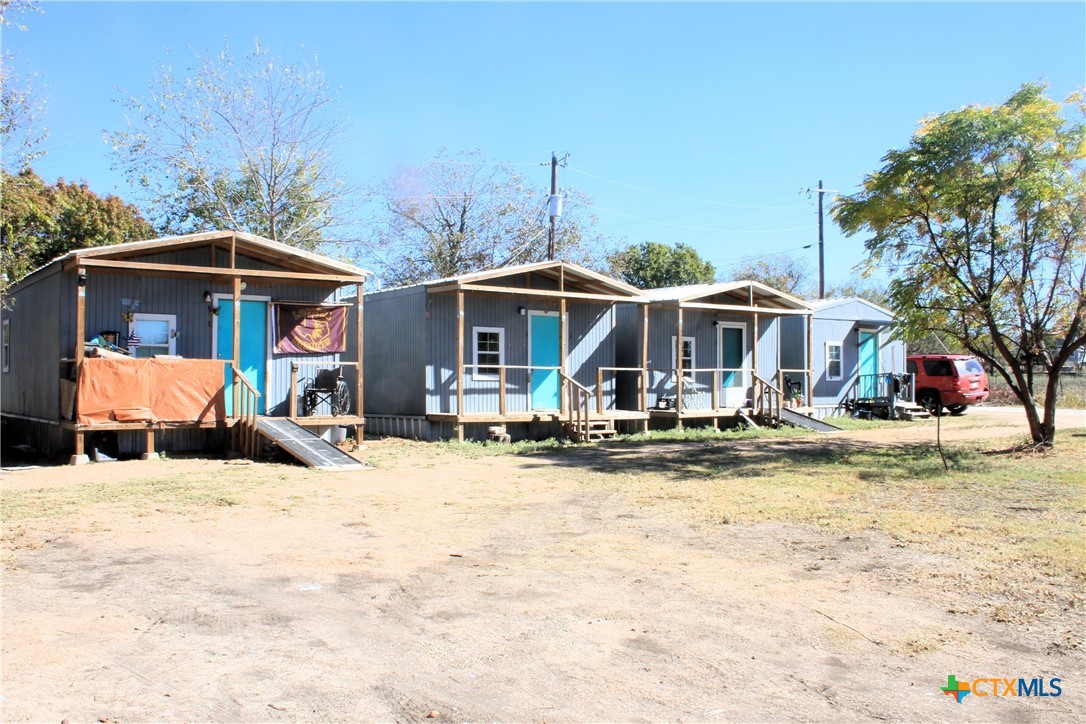 301 Cedar Street, Unit A Lometa, TX 76853 - Photo 2 of 13 a view of a house with swimming pool and sitting area