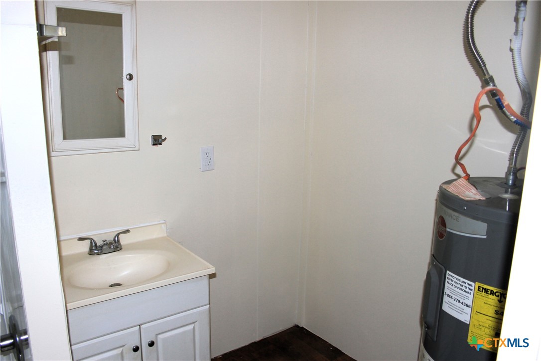 301 Cedar Street, Unit A Lometa, TX 76853 - Photo 9 of 13 a bathroom with a sink and a mirror