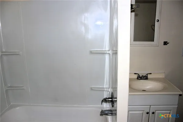 a kitchen with a refrigerator and a stove top oven