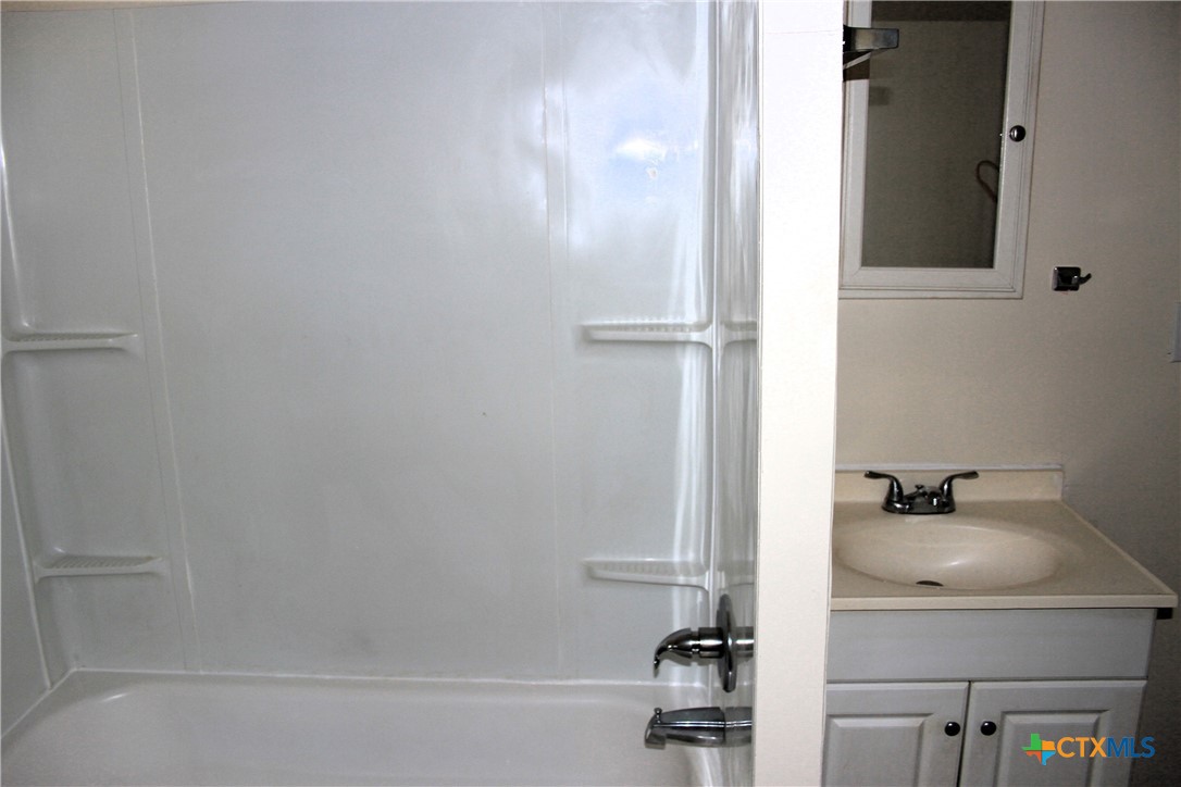 301 Cedar Street, Unit A Lometa, TX 76853 - Photo 10 of 13 a bathroom with a sink and a tub