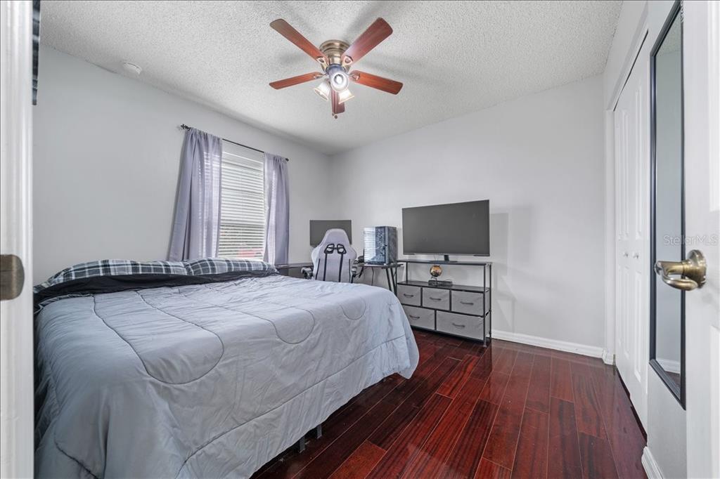 4721 Southwest 142nd Place Road Ocala, FL 34473 - Photo 16 of 25 a bedroom with a bed and a flat screen tv