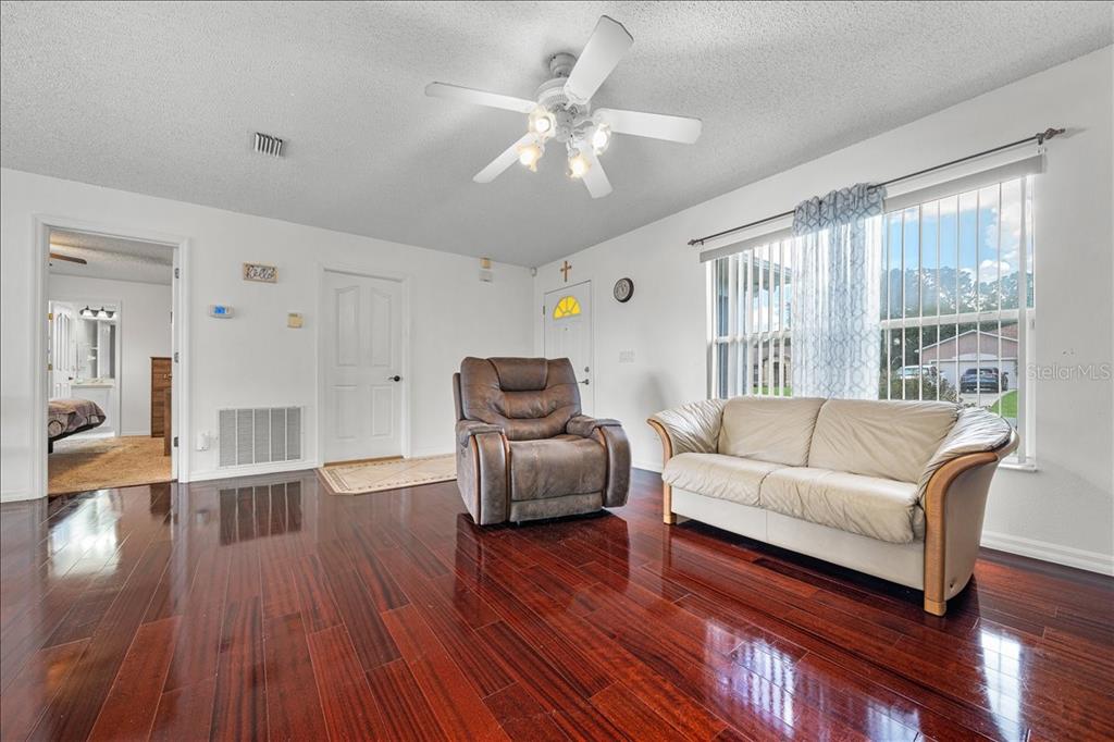4721 Southwest 142nd Place Road Ocala, FL 34473 - Photo 4 of 25 a living room with furniture and a large window