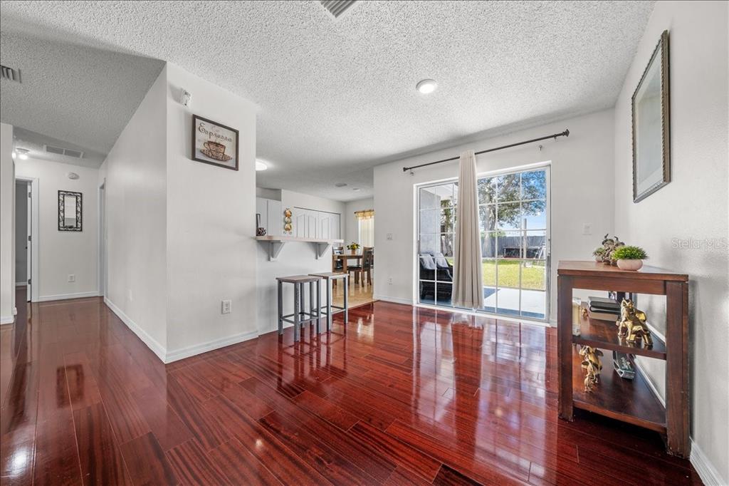4721 Southwest 142nd Place Road Ocala, FL 34473 - Photo 5 of 25 a living room with furniture and wooden floor