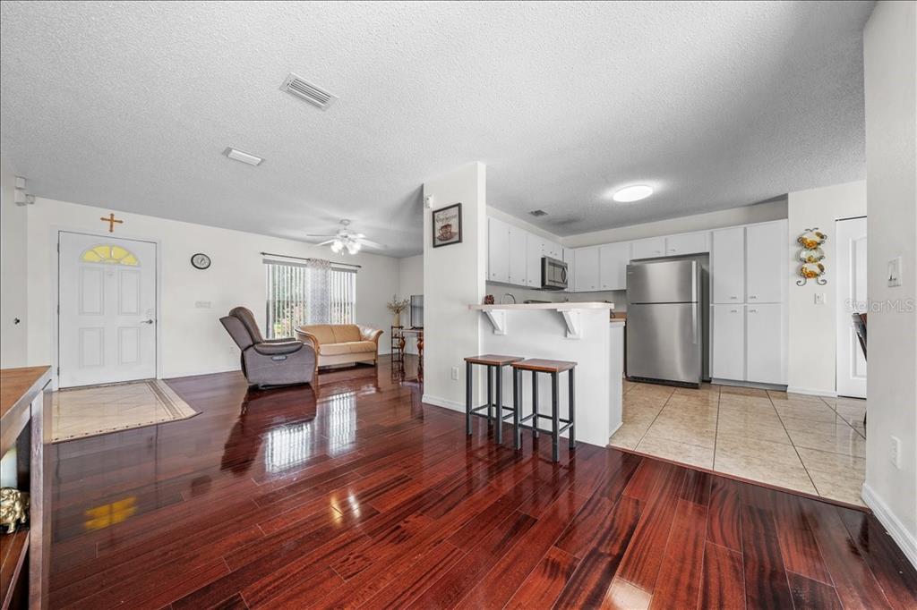 4721 Southwest 142nd Place Road Ocala, FL 34473 - Photo 6 of 25 a living room with furniture and a wooden floor