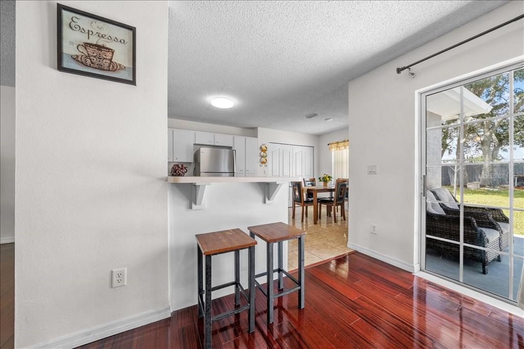 4721 Southwest 142nd Place Road Ocala, FL 34473 - Photo 7 of 25 a view of a dining room with furniture and wooden floor