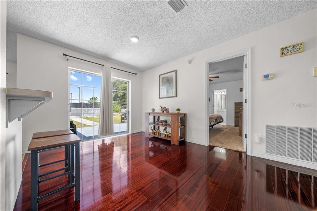 4721 Southwest 142nd Place Road Ocala, FL 34473 - Photo 8 of 25 a living room with furniture and a wooden floor