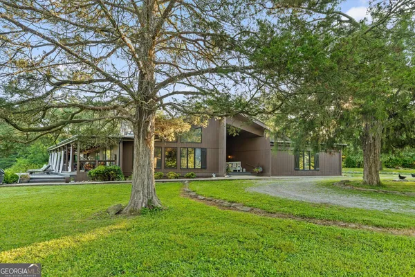 a front view of house with yard and green space