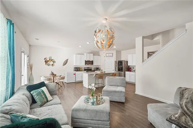 a living room with furniture or dining table and a large window