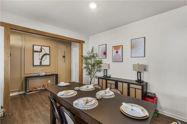 a view of a dining room with furniture and wooden floor