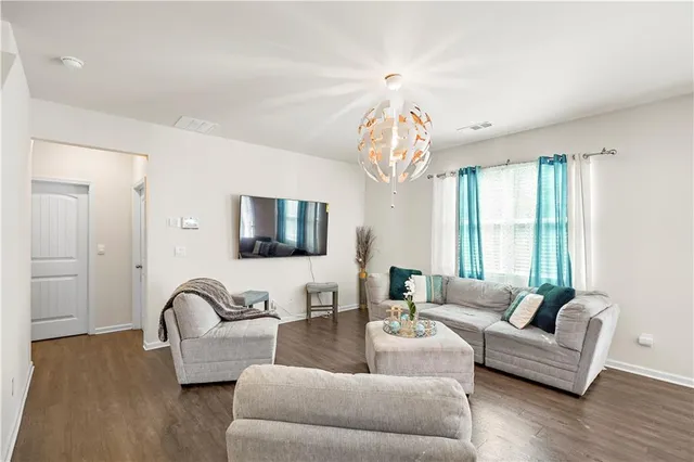 a living room with furniture and a chandelier