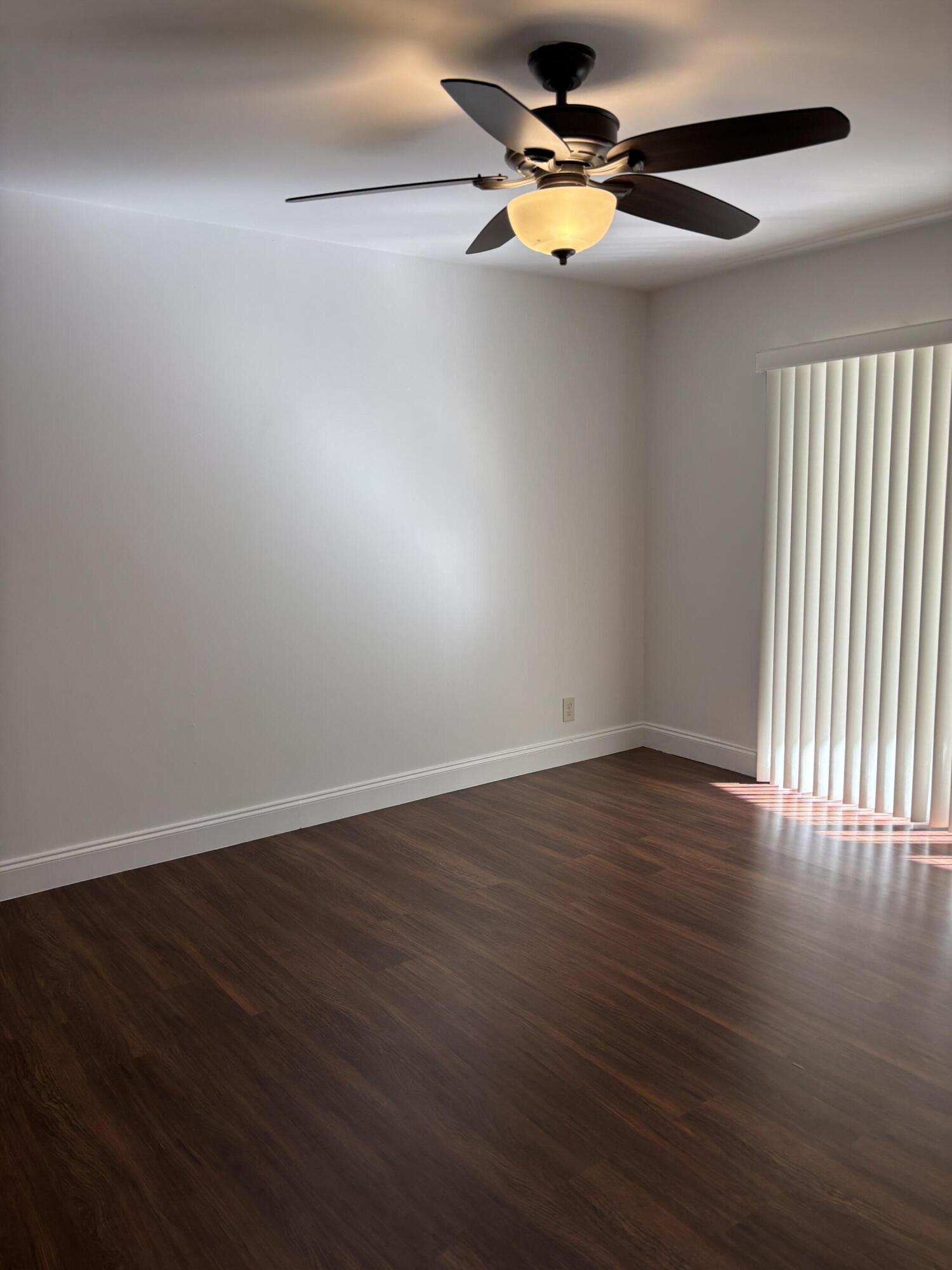 11608 Orange Blossom Lane Boca Raton, FL 33428 - Photo 12 of 18 a view of an empty room with wooden floor