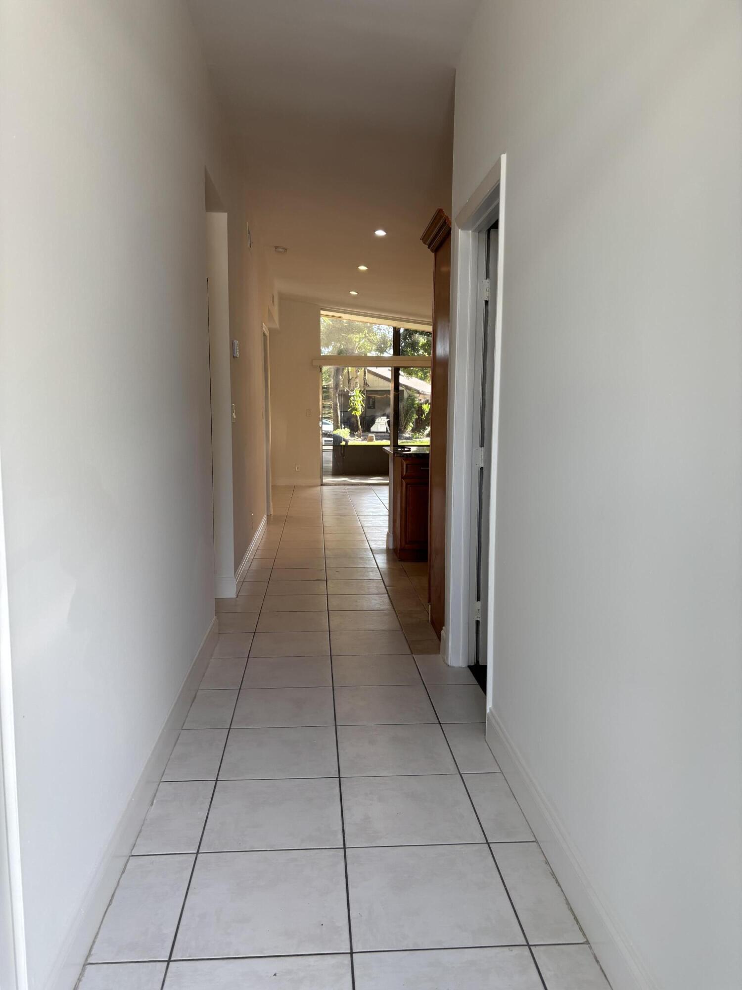 11608 Orange Blossom Lane Boca Raton, FL 33428 - Photo 2 of 18 a view of a hallway and a livingroom with a furniture