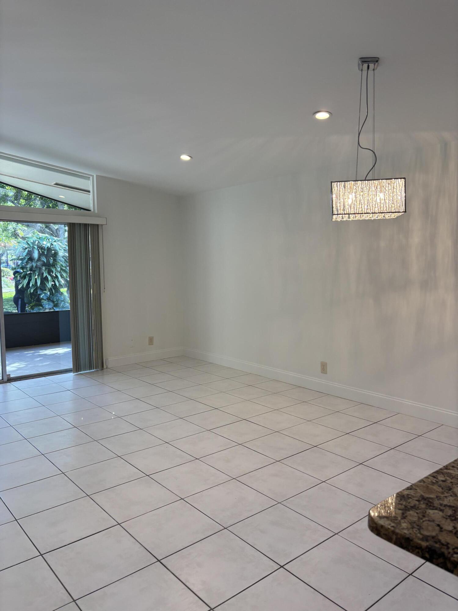 11608 Orange Blossom Lane Boca Raton, FL 33428 - Photo 5 of 18 a view of an empty room with a window