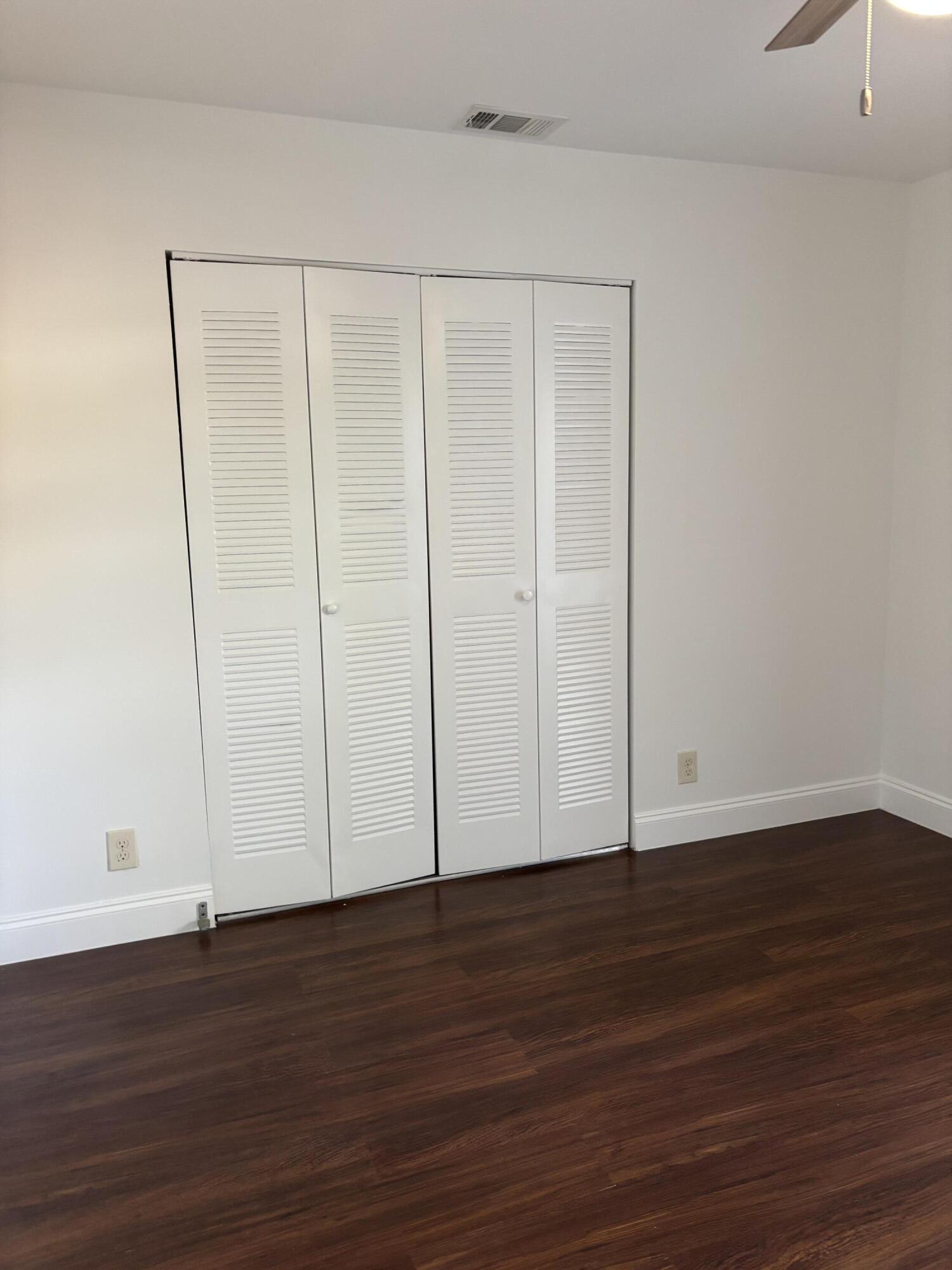 11608 Orange Blossom Lane Boca Raton, FL 33428 - Photo 8 of 18 a view of an empty room with wooden floor