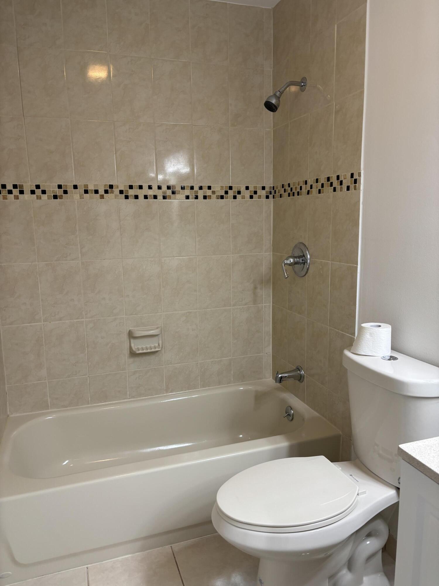 11608 Orange Blossom Lane Boca Raton, FL 33428 - Photo 10 of 18 a bathroom with a toilet and a shower