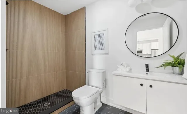 a bathroom with a sink toilet and a mirror