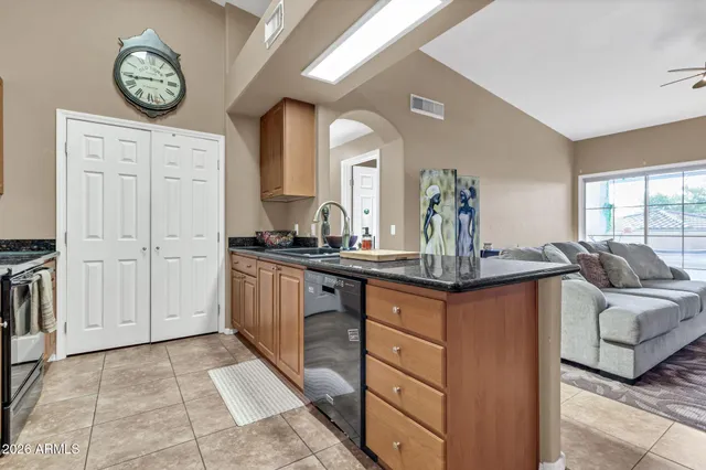 a kitchen with stainless steel appliances granite countertop a stove and a sink