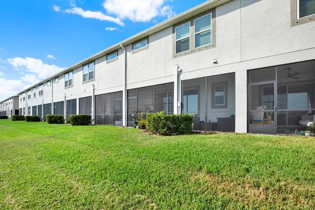 a view of a house with a yard and porch